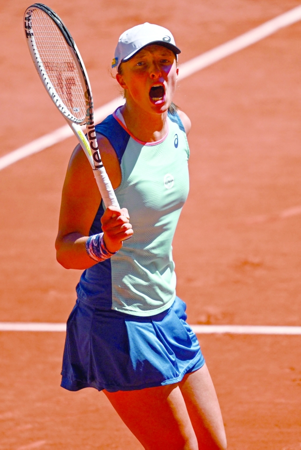Poland's Iga Swiatek celebrates after victory over Russia's Darya Kasatkina in their women's semifinal singles match on day twelve of the Roland-Garros Open tennis tournament at the Court Philippe-Chatrier in Paris on June 2, 2022. (Photo by Anne-Christine POUJOULAT / AFP)