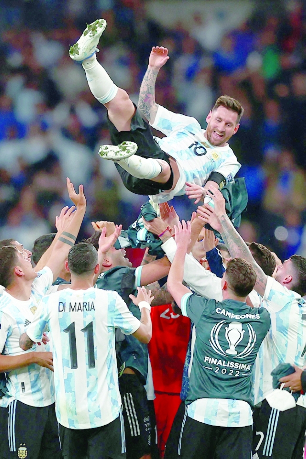 Argentina's striker Lionel Messi is thrown into the air by his teammates as they celebrate their win on the pitch after the 'Finalissima' International friendly football match between Italy and Argentina at Wembley Stadium in London on June 1, 2022. The Azzurri face the South American continental champions in the inaugural Finalissima at Wembley. (Photo by Adrian DENNIS / AFP)

