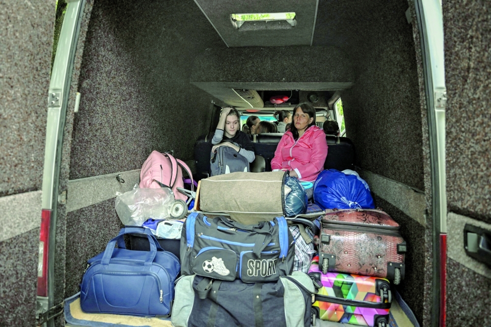 Residents evacuate the city of Sloviansk in the eastern Ukrainian region of Donbas on Thursday. - AFP

