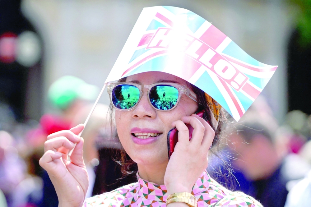 A girl holds a small Union flag in Trafalgar Sqaure 