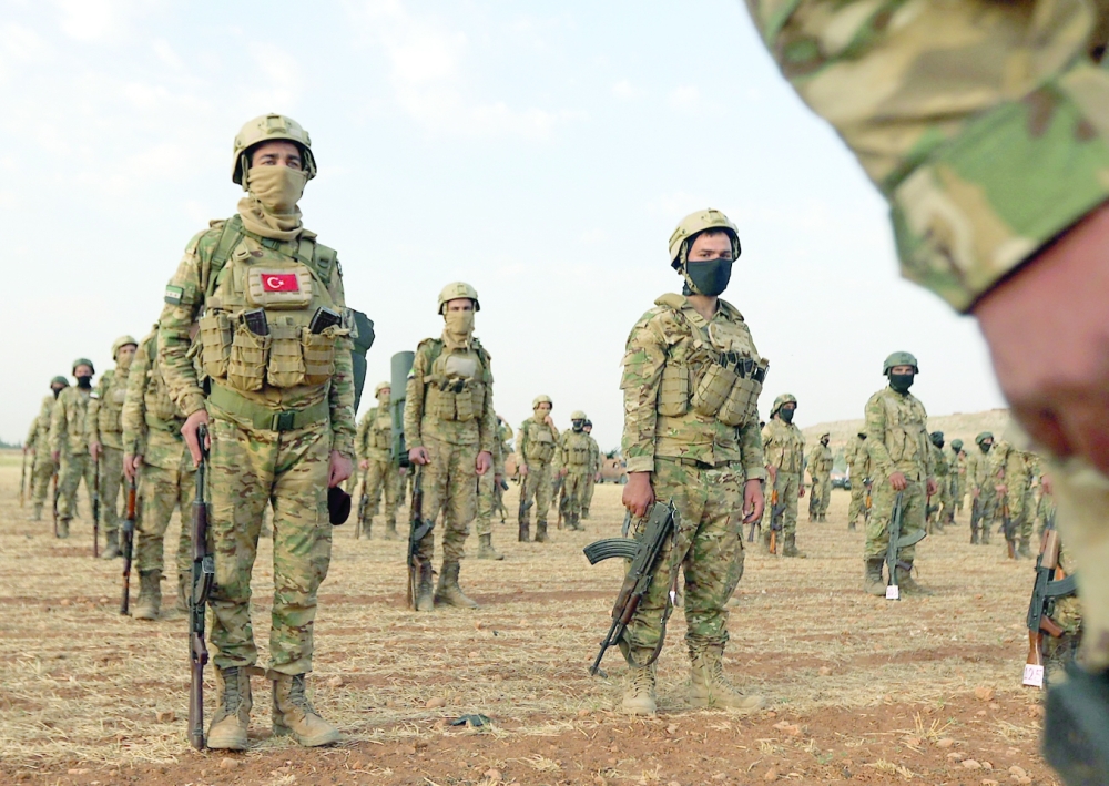 Syrian fighters gather in the countryside of the northern city of Manbij, on Thursday. - AFP