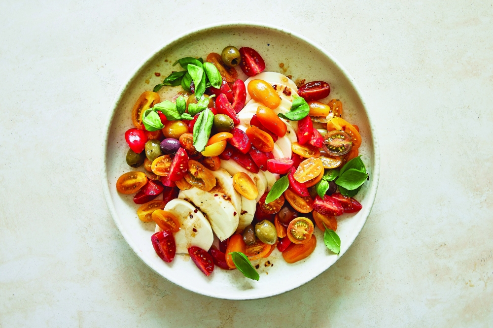 Caprese-style marinated mozzarella with cherry tomatoes and olives. (Kate Sears/The New York Times)