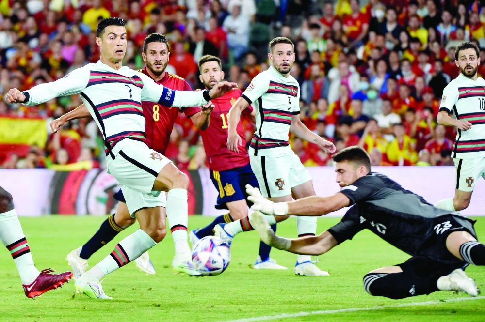 Portugal's Cristiano Ronaldo (left) misses an attempt to score during the UEFA Nations League, League A Group 2 match against Spain. -- AFP