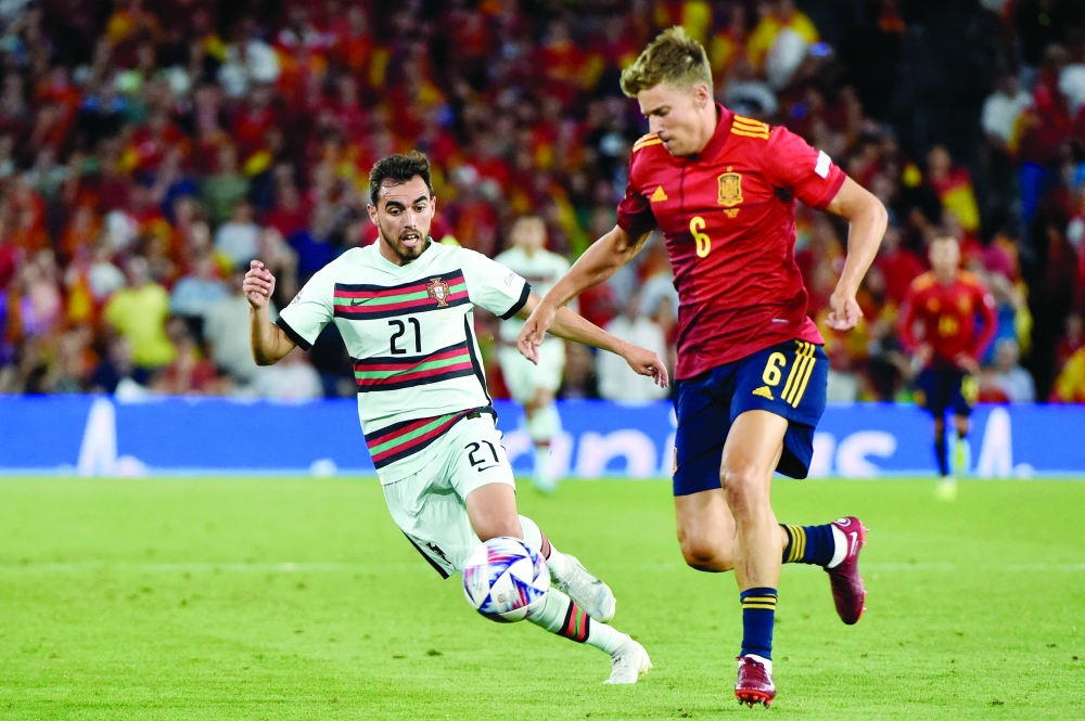 Portugal's forward Ricardo Horta (L) challenges Spain's midfielder Marcos Llorente. -- AFP