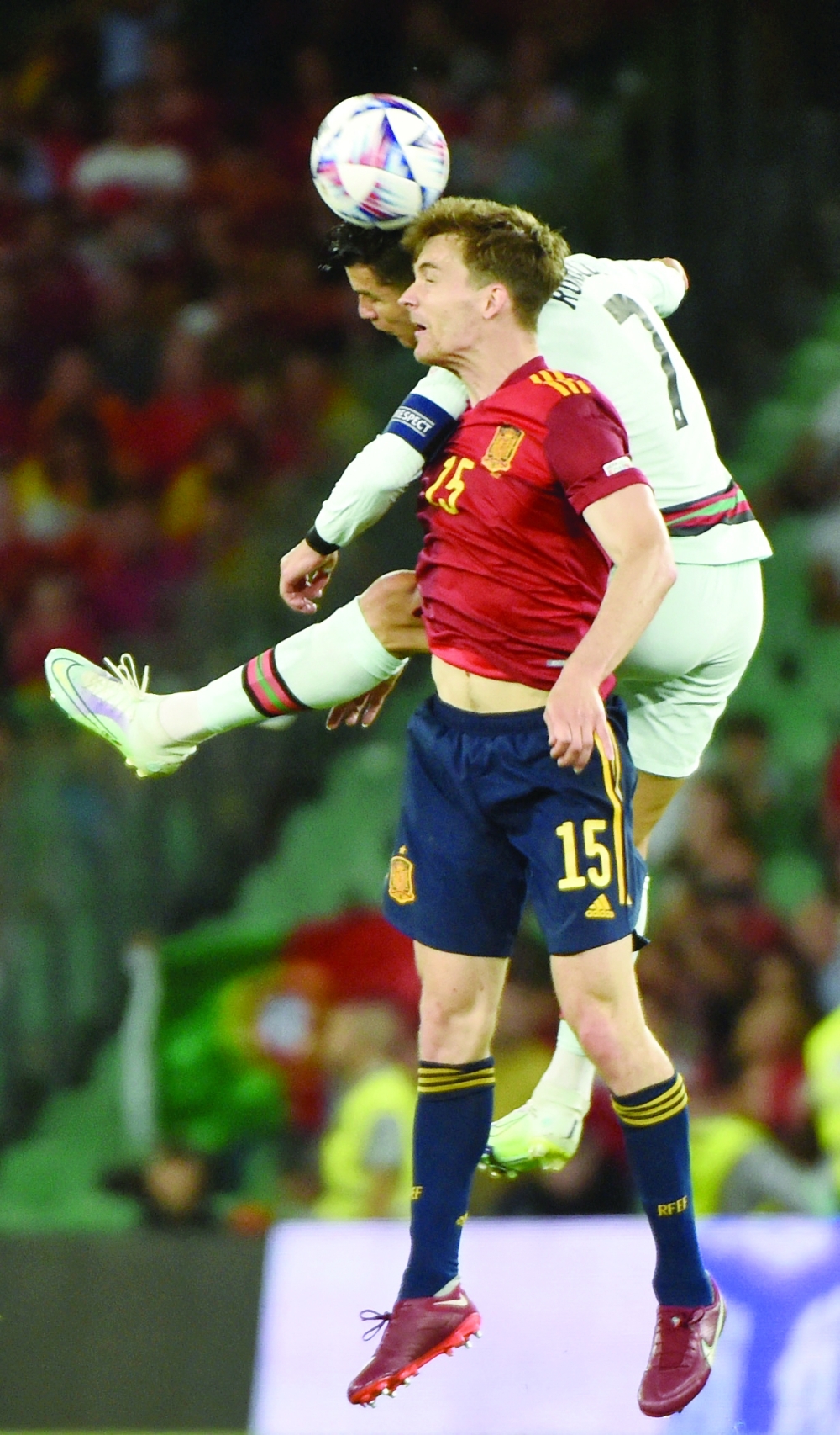 Portugal's Cristiano Ronaldo (back) vies for a header with Spain's defender Diego Llorente. -- AFP