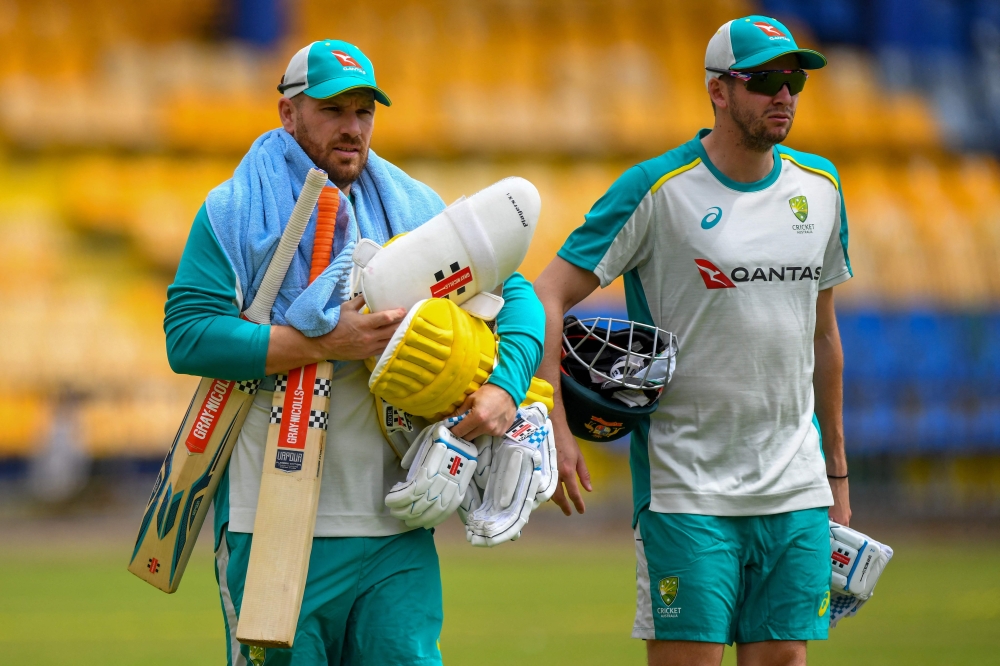 Australia's captain Aaron Finch (L) takes part in a practice session at the R. Premadasa Stadium in Colombo. -- AFP