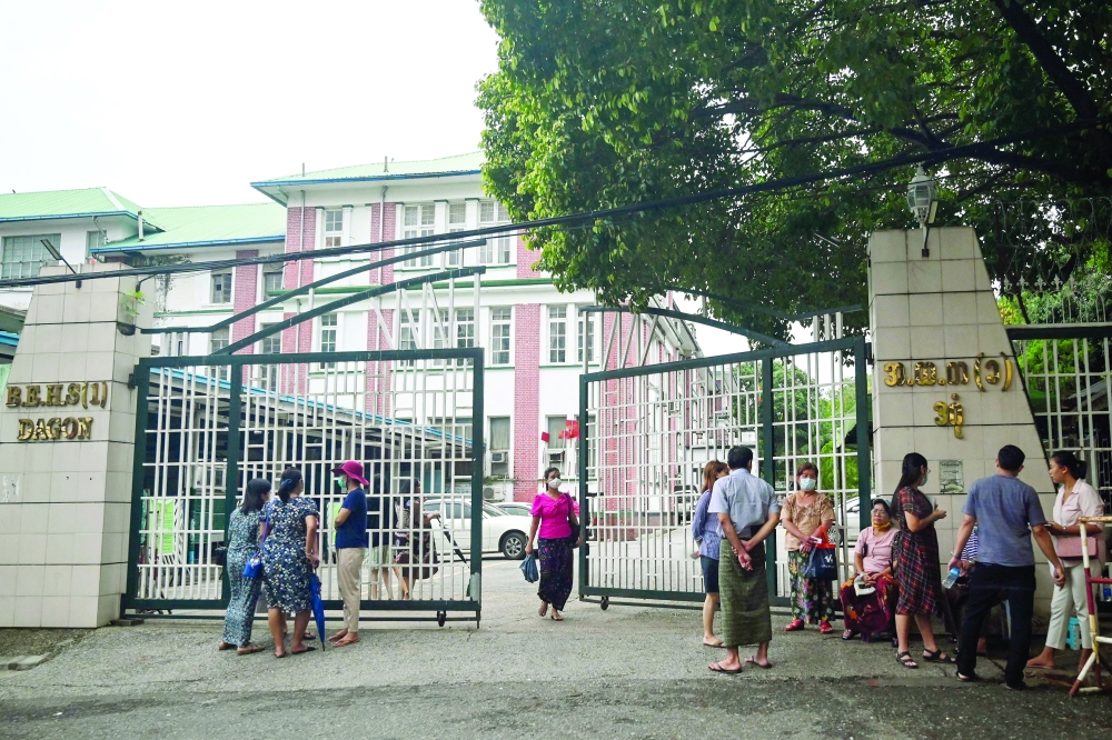 Parents wait to register their children at a school in Yangon on May 31 for the new school year starting on Thursday. - AFP