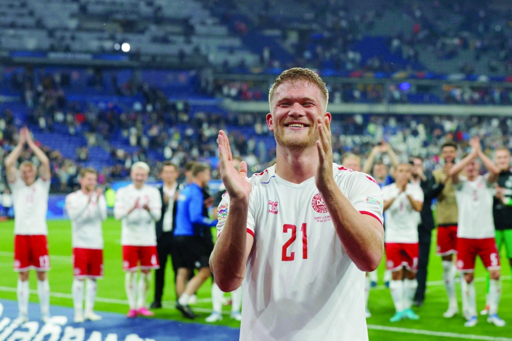 Denmark's forward Andreas Cornelius celebrates with team-mates after winning the UEFA Nations League. -- AFP