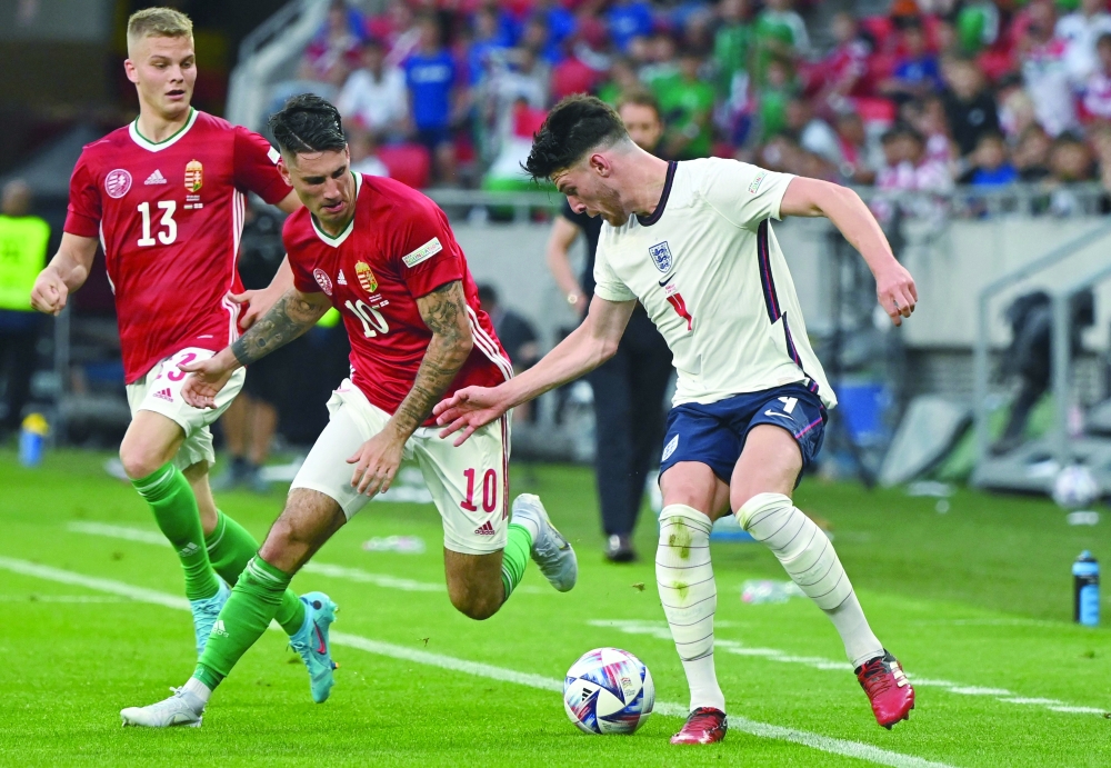 England's midfielder Declan Rice (R) and Hungary's midfielder Dominik Szoboszlai vie for the ball during the UEFA Nations League football match Hungary v England at the Puskas Arena in Budapest, Hungary, on June 4, 2022.

  (Photo by Attila KISBENEDEK / AFP)

