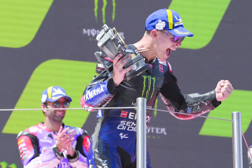 Yamaha French rider Fabio Quartararo celebrates on the podium after winning the Moto Grand Prix de Catalunya at the Circuit de Catalunya on June 5, 2022 in Montmelo on the outskirts of Barcelona. (Photo by LLUIS GENE / AFP)

