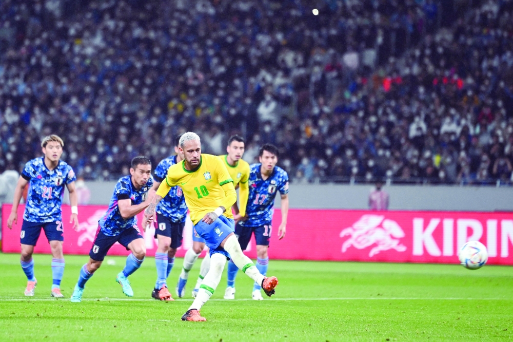Brazil's forward Neymar shoots to score a goal in a penalty kick during the friendly football match between Japan and Brazil at the National Stadium in Tokyo on June 6, 2022.  (Photo by CHARLY TRIBALLEAU / AFP)

