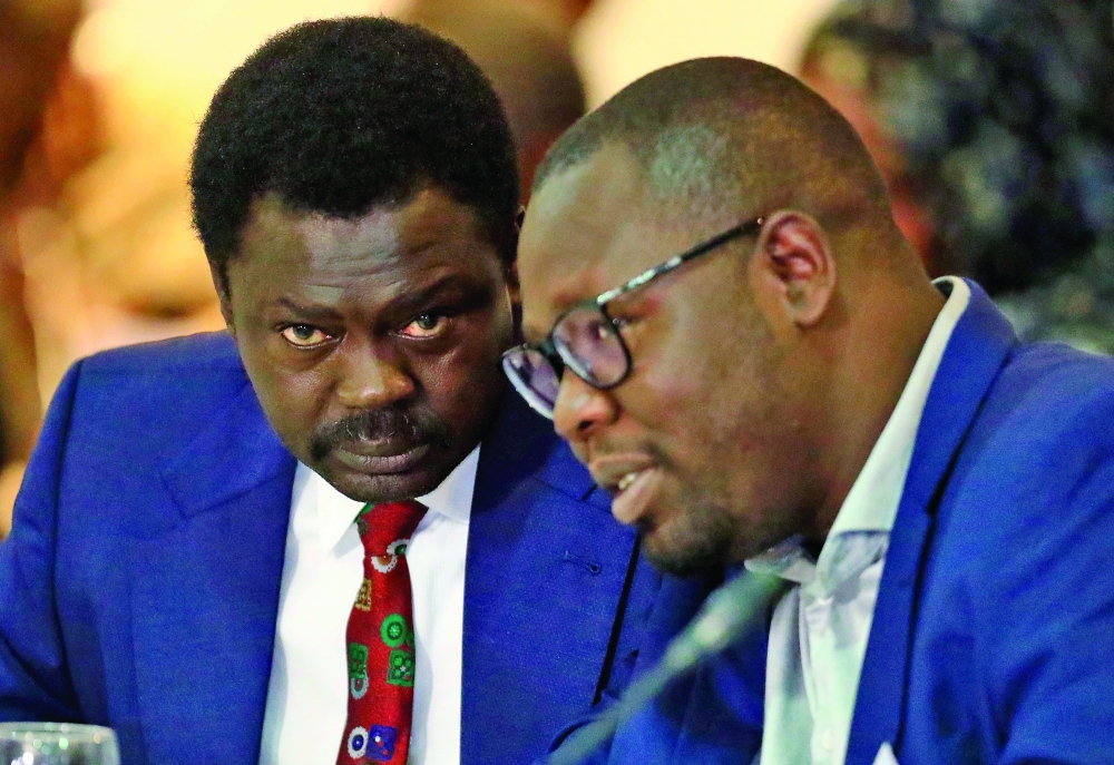 Mini Minawi, the Governor of Sudan's Darfur province, speaks with Mubarak Ardol, head of the Sudanese Mineral Resources Company, during a meeting of representatives of the tripartite mechanism in Khartoum. - AFP