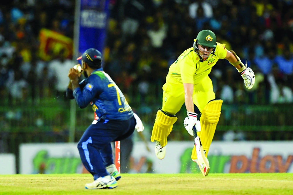 Australia's Jhye Richardson (R) runs to save his wicket during the second Twenty20 international cricket match between Sri Lanka and Australia at the R. Premadasa International Cricket Stadium in Colombo on June 8, 2022. (Photo by Ishara S. KODIKARA / AFP)

