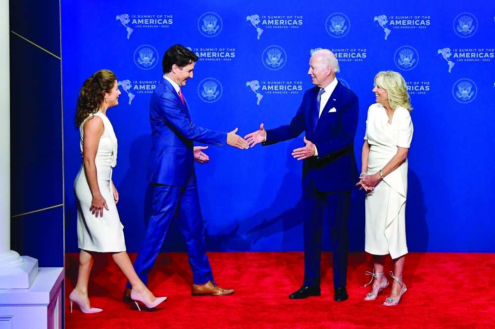 US President Joe Biden (2nd R) and First Lady Jill Biden (R) greet Canada's Prime Minister Justin Trudeau and his wife Sophie Gregoire Trudeau as they arrive for the 9th Summit of the Americas at the Los Angeles Convention Centre in Los Angeles, California on Wednesday. - AFP