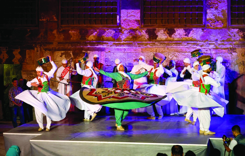 A troupe of whirling dervishes performs the traditional "tanoura" (skirt) dance in Cairo. — AFP