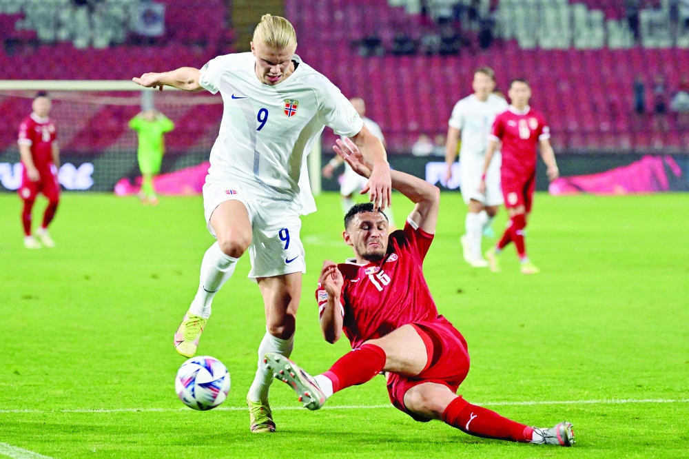 Norway's Erling Haaland (L) fights for the ball with Serbia's Milos Veljkovic during the UEFA Nations League. -- AFP