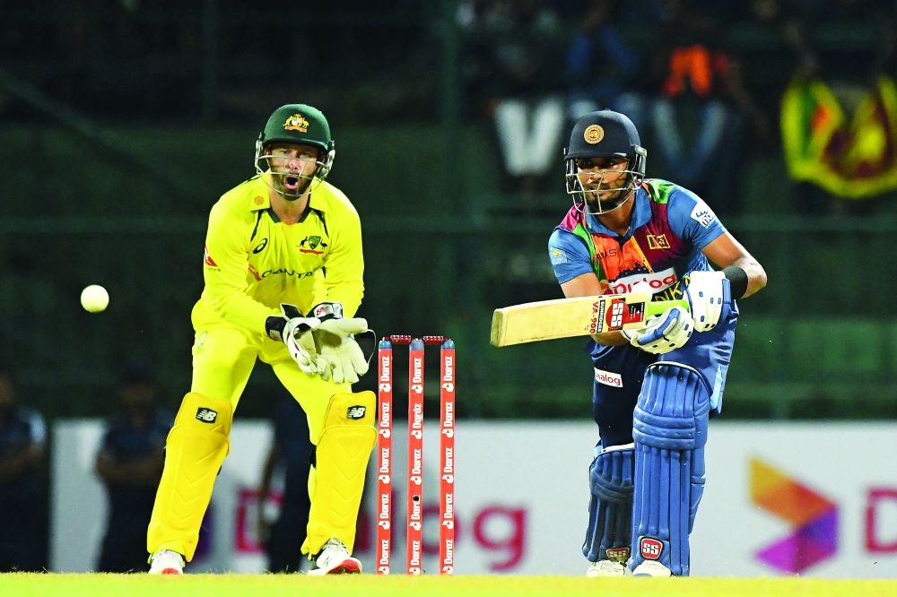Sri Lanka's Captain Dasun Shanaka (R) plays a shot during the third and final Twenty20 international cricket match between Sri Lanka and Australia at the Pallekele International Cricket Stadium in Kandy on June 11, 2022. (Photo by Ishara S. KODIKARA / AFP)

