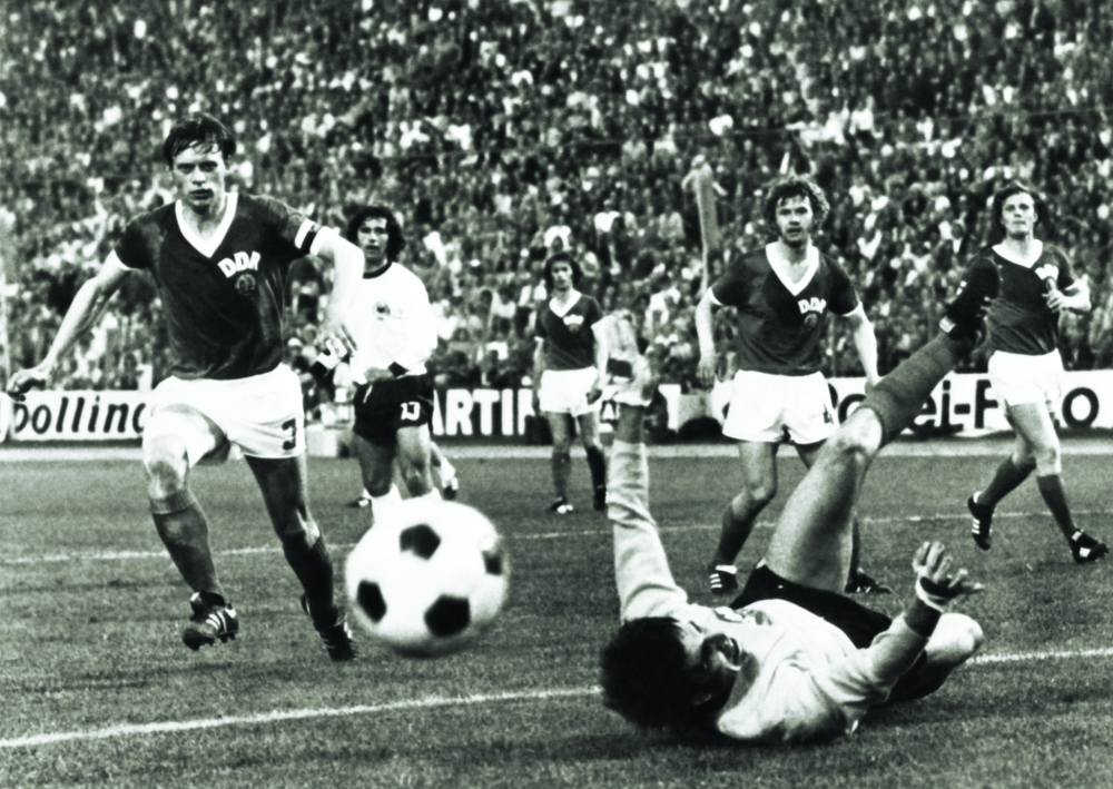 (FILES) In this file photo taken on June 22, 1974 East Germany's goalkeeper Jurgen Croy stops a goal of West Germany team, as (LtoR) Bernd Bransch (RDA), Gerd Müller (13-RFA), Konrad Weise (RDA) and Lothar Kurbjuweit (RDA) vie for the ball, during the World Cup first round football match between East Germany and West Germany in Hamburg, northern Germany, during which East Germany beat West Germany 1-0.  Former East Germany captain Bernd Bransch has died aged 77 after a long illness, his old club Halle said in a statement on June 12, 2022. Bransch played 72 times for East Germany and was twice voted East German footballer of the year.
 (Photo by AFP)

