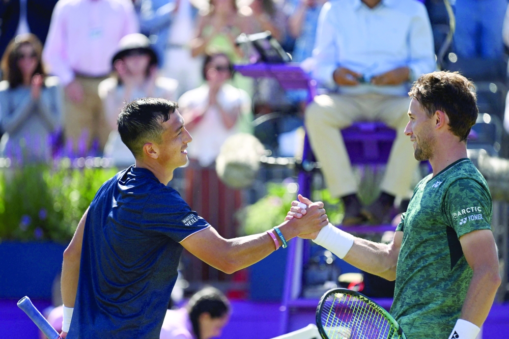 Britain's Ryan Peniston shakes hands with Norway's Casper Ruud. -- AFP