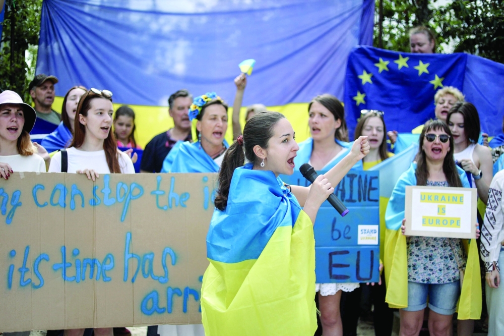 Demonstrators gather outside the European Headquarters part as they protest in support of Ukraine's application for EU candidacy status during an EU-Western Balkans leaders' meeting in Brussels on Thursday. - AFP