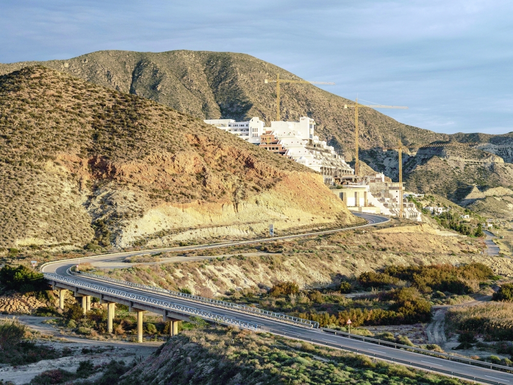 Construction cranes still stand over the unfinishedHotel El Algarrobico in Almeria, Spain, on Dec. 26, 2021, even as the structure molders. (Ben Roberts/The New York Times)