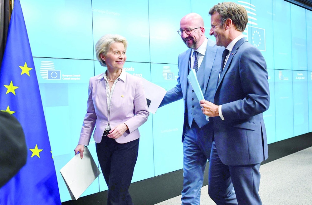 President of the European Commission Ursula von der Leyen (L), President of the European Council Charles Michel (C) and France's President Emmanuel Macron  leave after holding a press conference during an European Council in Brussels on Thursday. - AFP