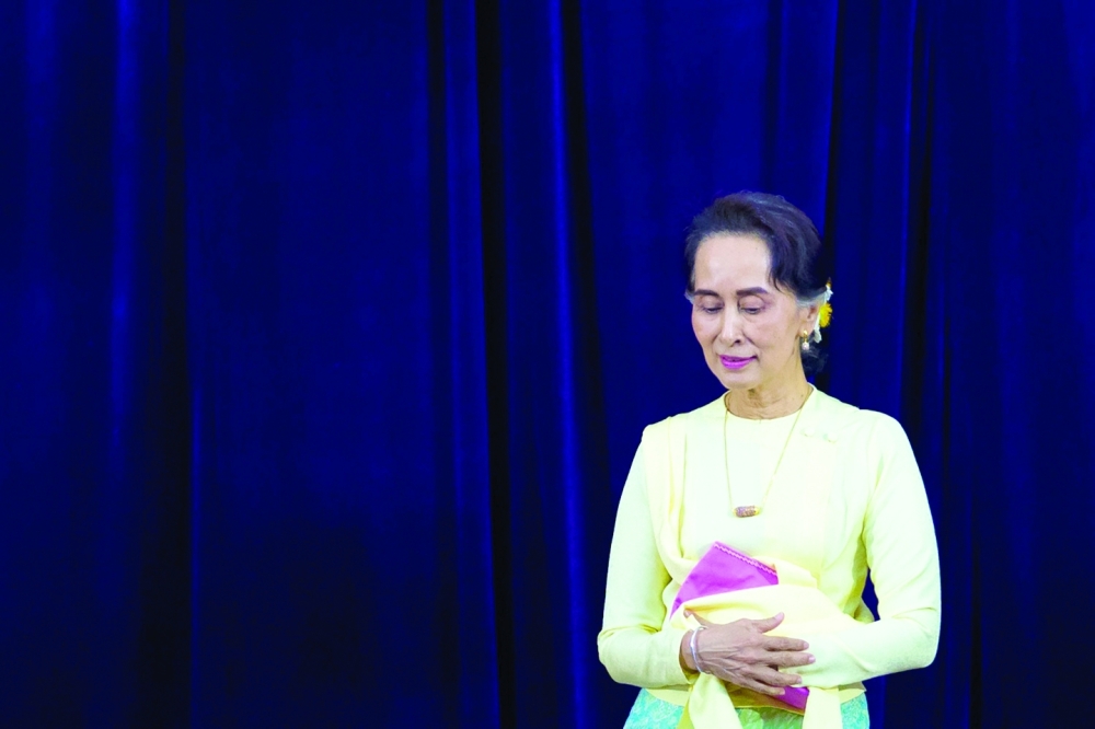 (FILES) In this file photo taken on August 29, 2018, Myanmar State Counsellor Aung San Suu Kyi leaves after delivering address before students of Yangon University general assembly in Yangon. Ousted Myanmar leader Aung San Suu Kyi has been moved from house arrest to solitary confinement in a prison compound in the military-built capital Naypyidaw, a junta spokesman said on June 23, 2022. (Photo by AFP)
