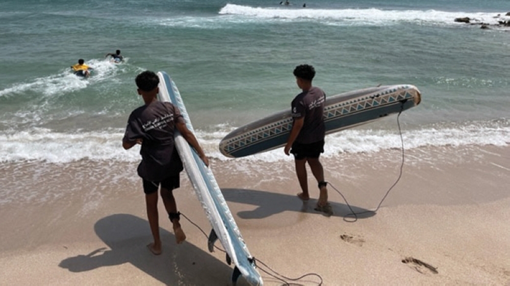 surfers-heading-into-water