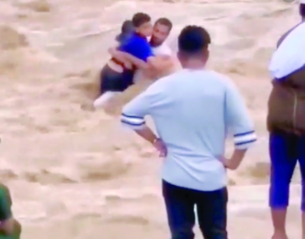 Video grab showing Ali bin Nasser al Wardi saving two kids in Bahla on Saturday.