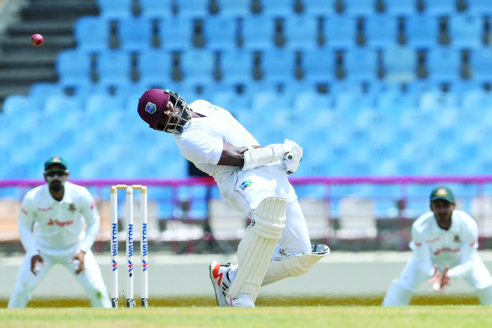 TOPSHOT - Kyle Mayers, of West Indies, takes evasive action during the second day of the 2nd Test between Bangladesh and West Indies at Darren Sammy Cricket Ground in Gros Islet, Saint Lucia, on June 25, 2022. (Photo by Randy Brooks / AFP)

