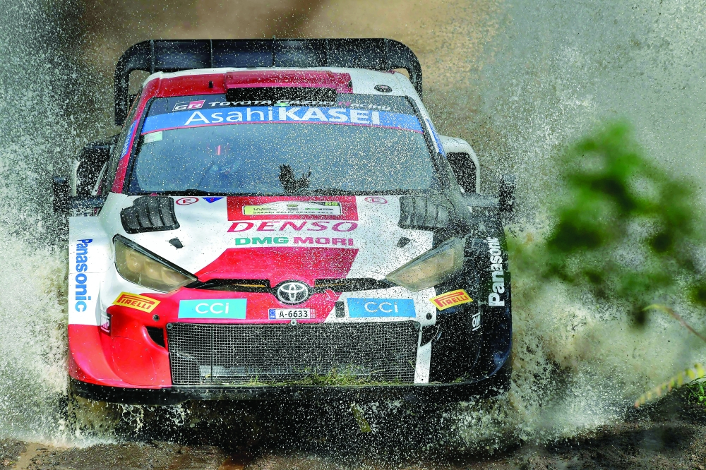Finnish crew, Kalle Rovanpera, navigated by Jonne Halttunen, splash across a stream in their Toyota GR Yaris at the Soysambu section in Nakuru county, Kenya on June 25, 2022. Kalle Rovanperن continued to dominate the WRC Kenya on Saturday, with Toyota placing four cars in the top four positions going into the final day on Sunday, while Hyundai had a disastrous day. (Photo by Tony KARUMBA / AFP)

