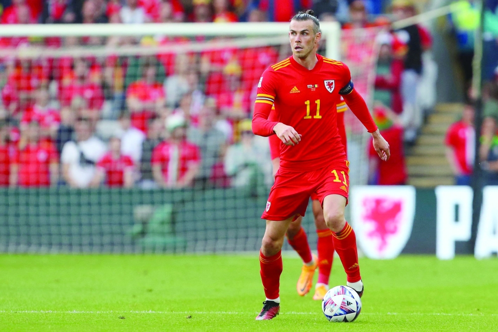 (FILES) In this file photo taken on June 11, 2022, Wales' midfielder Gareth Bale runs with the ball during the UEFA Nations League - League A Group 4 football match between Wales and Belgium at the Cardiff City Stadium in Cardiff. Wales captain Gareth Bale is set to join Los Angeles FC following his departure from Real Madrid, reports in Britain and the US said on June 25, 2022. (Photo by Geoff Caddick / AFP)