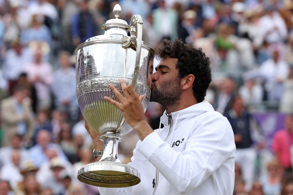 Italy's Matteo Berrettini kisses the trophy as he celebrates his ATP Championship win. -- AFP File Photo