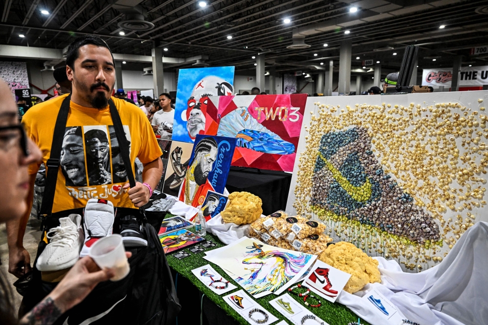 People look at a shoe art made from popcorn during the “Got Sole” Sneaker Convention in Miami, Florida on June 26, 2022.  (Photo by CHANDAN KHANNA / AFP)


