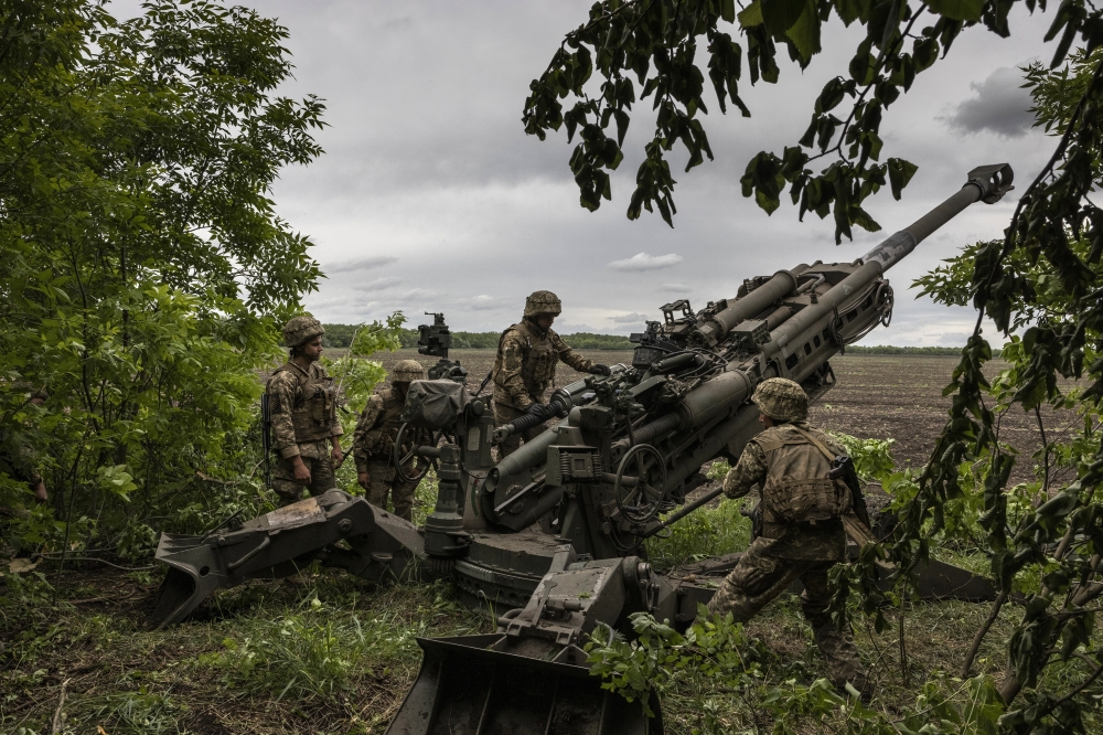 Ukrainian troops load a Howitzer M777 155mm artillery piece in Donetsk region of eastern Ukraine.

