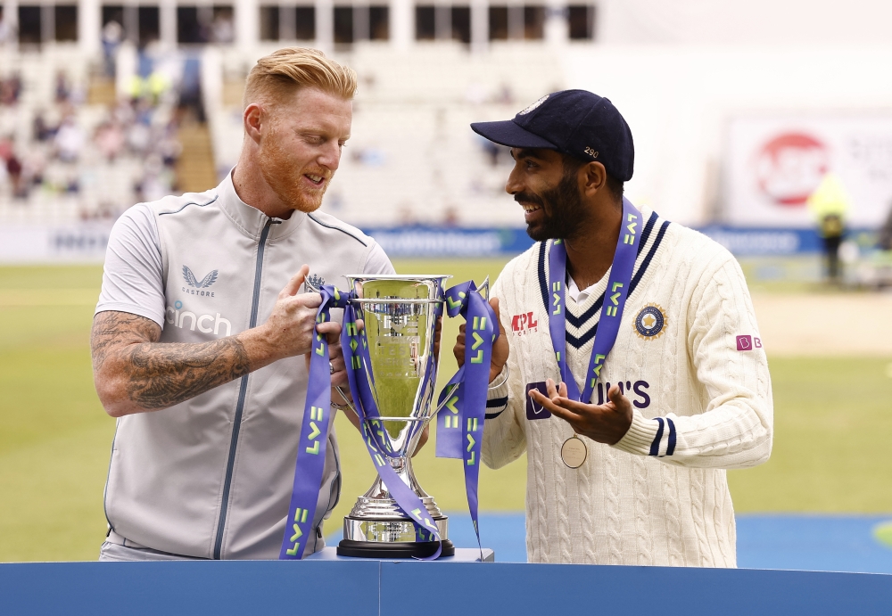 England's Ben Stokes and India's Jasprit Bumrah pose with the LV trophy after the match. -- Reuters