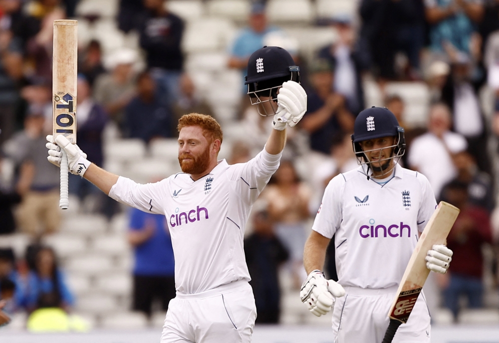 England's Jonny Bairstow celebrates reaching his century with Joe Root. -- Reuters