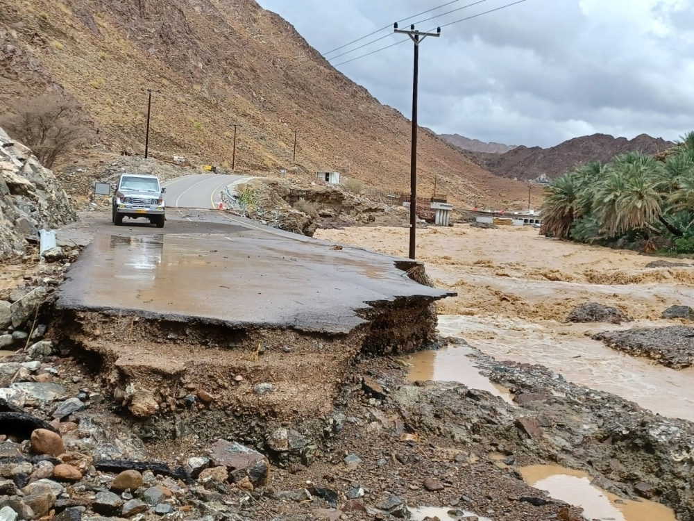 A damaged road is seen in Saham after flash floods on Thursday 