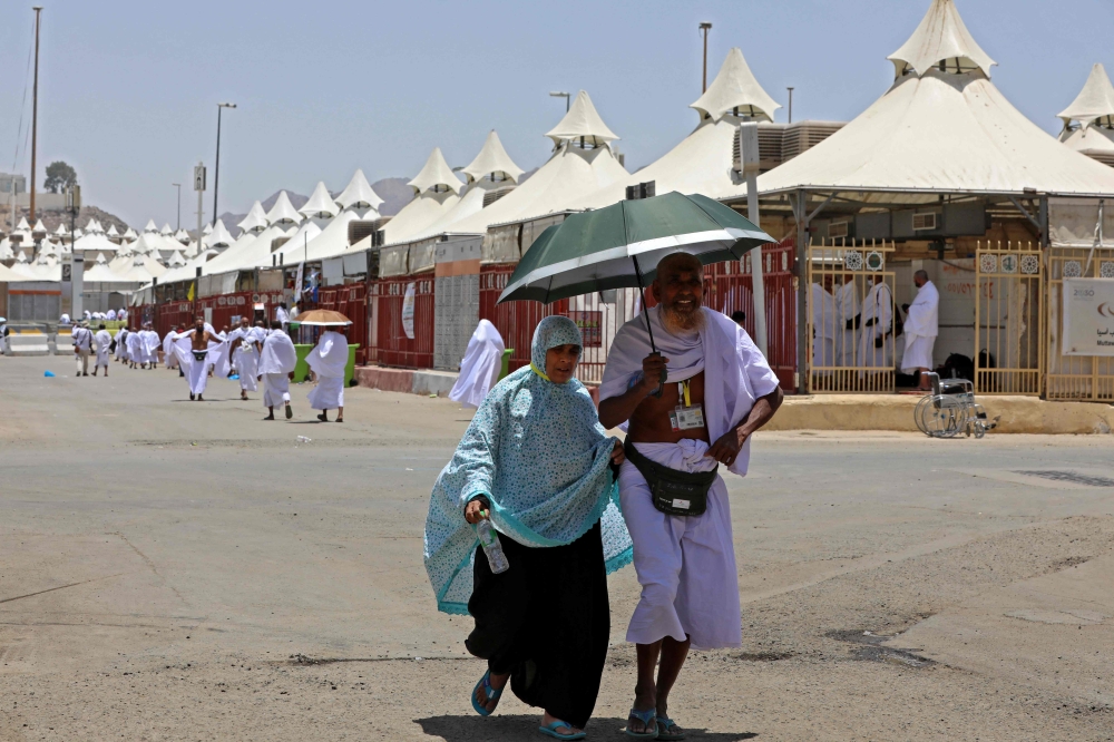 Pilgrims arrive to their camp in Mina. - AFP  

