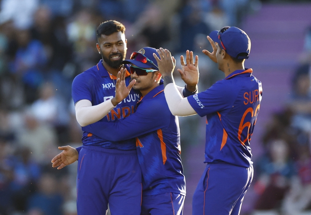 India's Hardik Pandya celebrates with teammates after taking the wicket of England's Dawid Malan. -- AFP