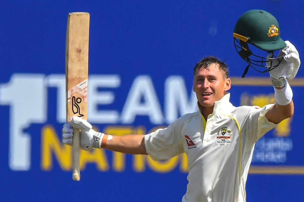 Australia's Marnus Labuschagne raises his bat after scoring a century (100 runs) during the first day of second Test match against Sri Lanka. -- AFP