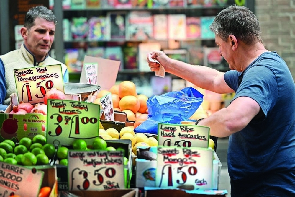 A man busy fruits at a local fruit stand in central London. — AFP