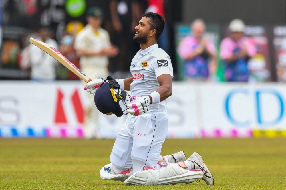 Sri Lanka's Dinesh Chandimal celebrates after scoring a double hundred during the fourth day of the second Test against Australia in Galle. -- AFP