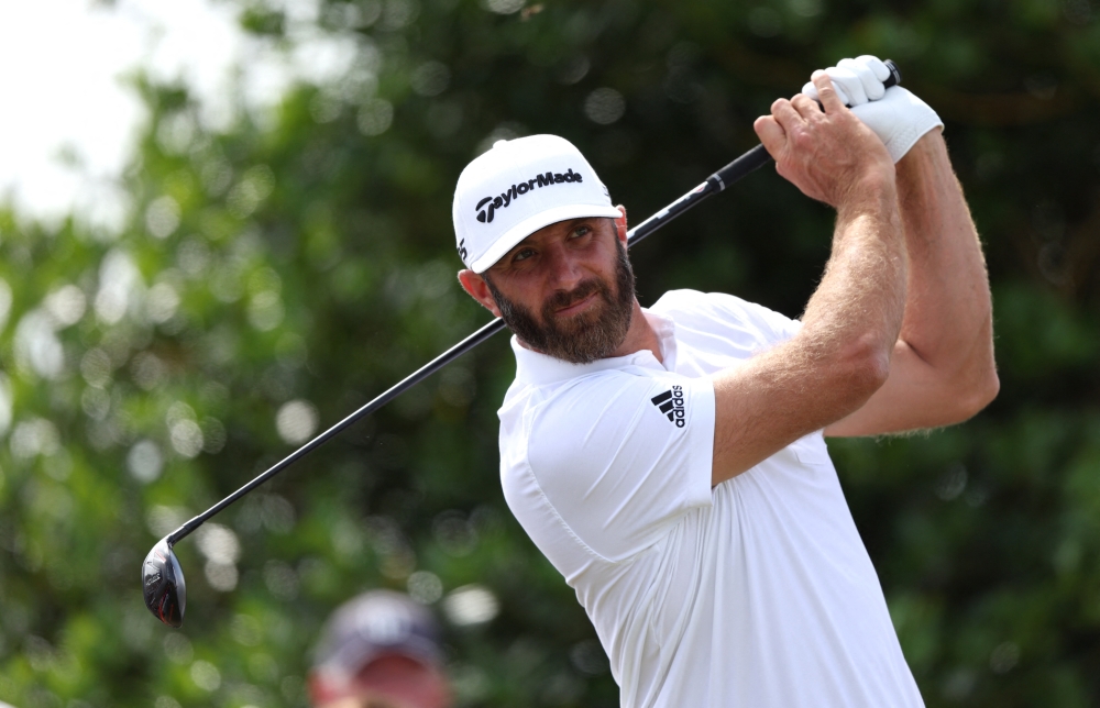Dustin Johnson of the US tees off on the 3rd during a practice round. -- Reuters