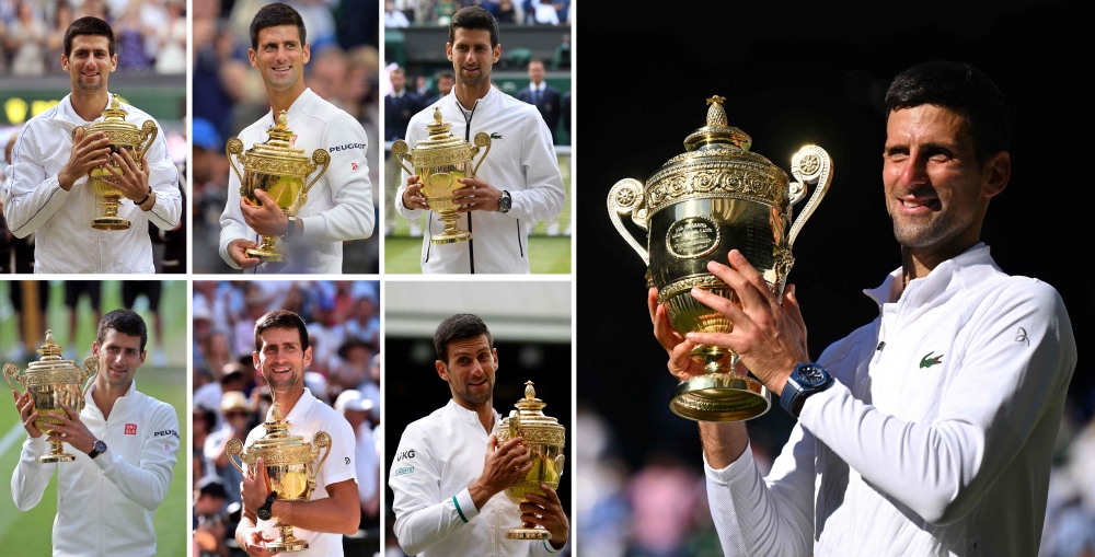 A combination of photographs created on July 10, 2022 shows Serbia's Novak Djokovic (R) holding up the Wimbledon Championships trophy after winning his seventh men's singles titles at The All England Tennis Club in Wimbledon. -- AFP