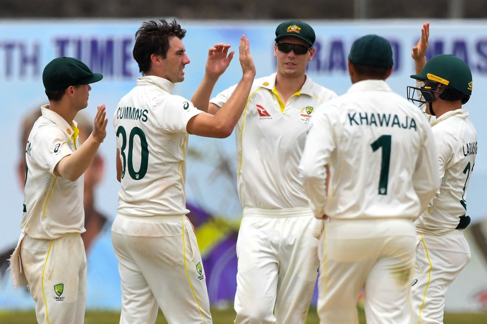 Australia's captain Pat Cummins (2L) celebrates with team-mates after taking wicket of Sri Lanka's Maheesh Theekshana. -- AFP