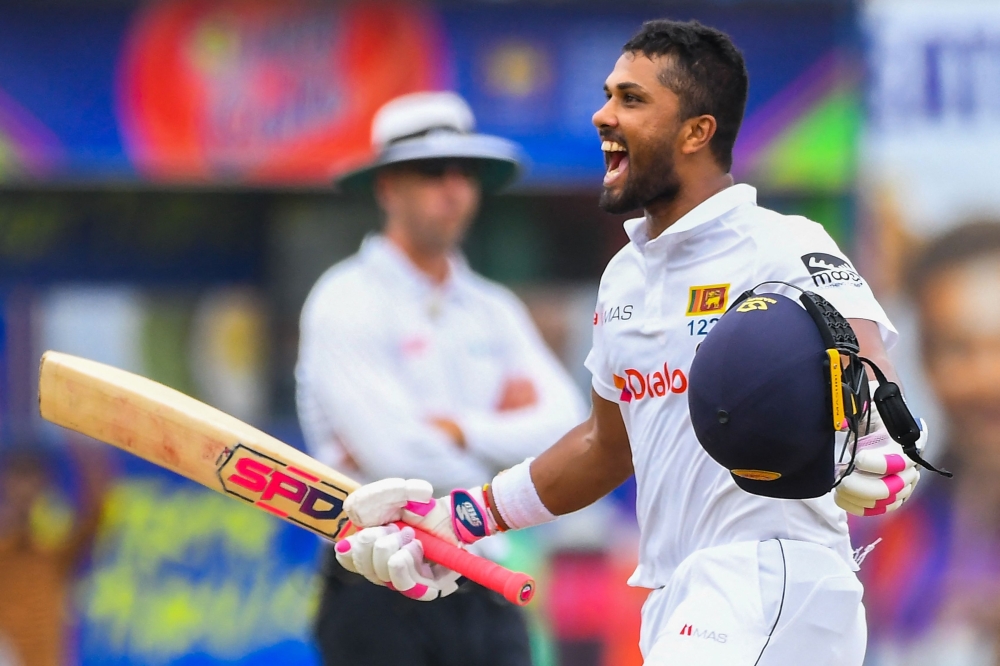 Sri Lanka's Dinesh Chandimal celebrates after scoring a double hundred during the fourth day of the second Test against Australia in Galle. -- AFP