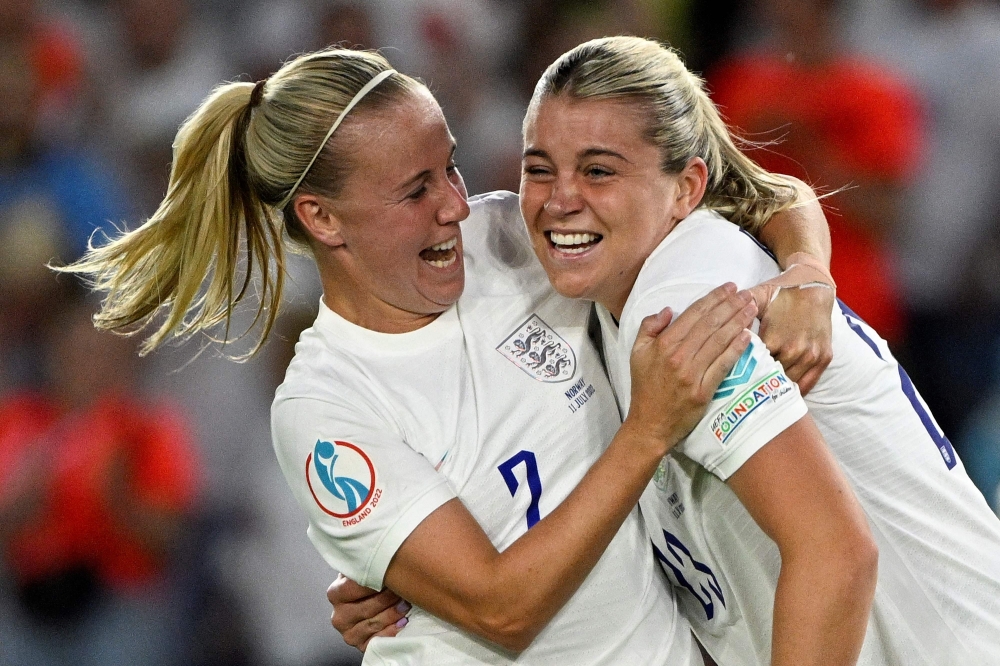 England's striker Alessia Russo (R) celebrates scoring the team's seventh goal. -- AFP