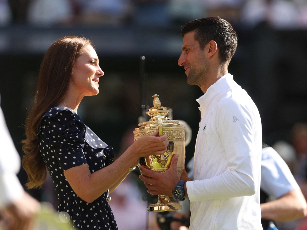 Britain’s Catherine, the Duchess of Cambridge presents the trophy to Serbia’s Novak Djokovic after he won the Wimbledon final. — Reuters
