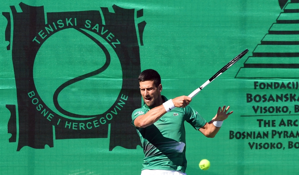 Novak Djokovic returns the ball during an exhibition match, organised to mark the opening of a tennis court at the "Archaeological park of the Bosnian pyramid" near Visoko, north of Sarajevo. -- AFP